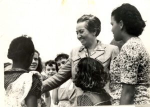 Gabriela Mistral; famous for her poems & stories for children and her work for UNICEF, the 'bard of mother and children' talks to a group of children. Credit - Doris Dana. ·# 19" Donation from Doris Atkinson in 2007 to the National Library of Chile
